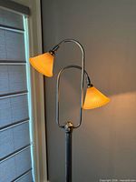 Entire lamp showing two arms with lit shades