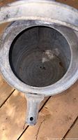 Interior of galvanized watering can showing metal surface