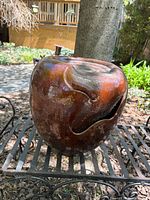 Front view of glazed ceramic fountain urn showing main decorative opening