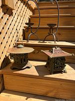 Lanterns and candle holders on wooden steps showing overall lot