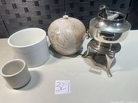Group shot showing all four items: percolator on stand, spherical vase, large porcelain planter, small cup