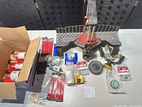 Overall lot layout showing miter box, hole saws, drill bits and accessories