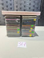 Full front view of two stacks of 30 CDs in Streisand slipcase