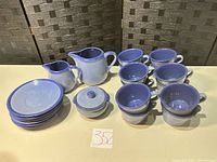 Full set showing 8 cups, 6 saucers, large pitcher, creamer, lidded sugar bowl