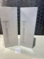 Two unopened Crate & Barrel lantern boxes