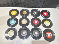 Twelve 7 inch singles arranged label-side up