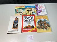 All six hardcover books laid out showing fronts