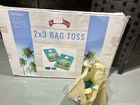 Retail box showing Margaritaville 2x3 Bag Toss set with tote holding bean bags