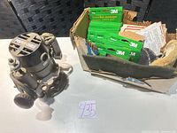 Router alongside box of 3M sanding discs