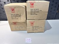 Four labeled cardboard boxes for individual porcelain houses