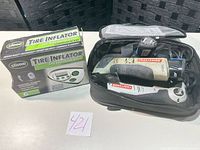 Overall lot: inflator box and bag with Craftsman tools, batteries, charger