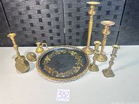 Group view of all candlesticks, chamberstick, bird figurines and toleware tray