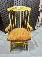 Front view of yellow Windsor spindle-back rocking chair with cushion