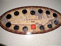 Front of oval display folder showing 13 coins in map design