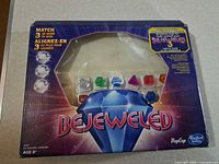 Front of Bejeweled board game box showing contents through plastic window