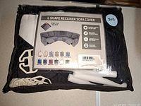 Front of packaged L-shape recliner sofa cover showing product label and included accessories