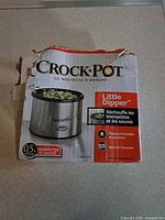 Torn retail box showing Crock-Pot Little Dipper branding and capacity information