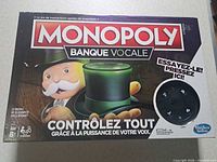 Front of Monopoly Banque Vocale box showing branding, age rating, and image of electronic hat