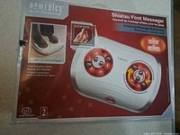 Front of retail box showing HoMedics FM-9 Shiatsu Foot Massager image and features