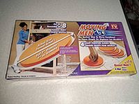 Front of sealed Moving Men 8-piece slider set box
