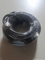 Coiled black RG-8 cable shrink-wrapped, one PL-259 connector visible