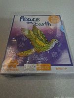 Front of sealed box showing Peace on Earth dove design and 200 piece count