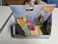 Front view showing Raya figure and Tuk Tuk vehicle inside box