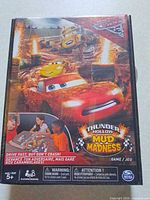 Front of sealed Cars Thunder Hollow Mud Madness board game box