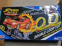 Front of sealed box showing Speed Way branding, red pull-back car, dual loops, 100" track info