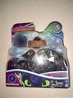 Front of sealed blister pack showing figures, egg and nest