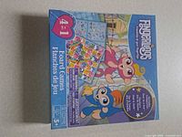 Front of sealed Fingerlings 4-in-1 board games box showing age rating and bilingual text.