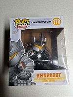 Front view of boxed Reinhardt Pop! showing Overwatch branding and figure inside