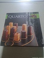 Front of Quarto game box showing product image and branding