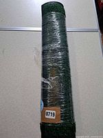 Full view of rolled artificial turf wrapped in plastic showing length