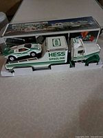 truck and race car seated in inner tray within open box