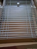Boxed white coated wire panels showing powder-coated finish and wood side pieces