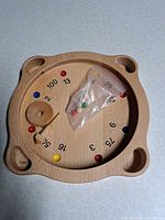 Top view of wooden board with marbles and spinning top