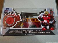 Front of boxed M&M's fire truck candy dispenser showing red M&M firefighter and product branding