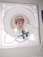 Front view of plate in foam showing portrait and 3-D rose