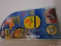 Front of sealed blister package showing Package Shark Pro branding and product