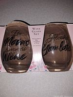 Front view of both glasses in package showing texts