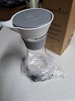 Carafe with lid and box showing brand and silicone grip