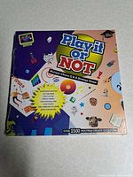 Front view of sealed Play It or NOT board game box