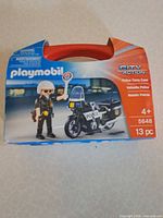Front of Playmobil City Action Police Carry Case box showing set image