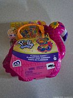 Front view of sealed Polly Pocket Flamingo Party playset in flamingo-shaped case