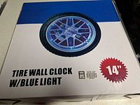 Box front showing image of tire wall clock and size information