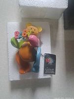 Figurine in styrofoam insert with hang tag visible