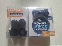 Front view of sealed Rising Star Milestone Set showing socks, stickers, bow tie