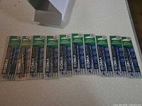 Ten individually carded RONA 3/16-inch masonry hammer drill bits laid out