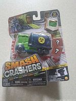 Front view of sealed Smash Crashers Series 1 truck set